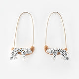 White leopard earrings on its branch