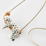 White leopard earrings on its branch