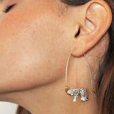White leopard earrings on its branch