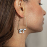 White leopard earrings on its branch