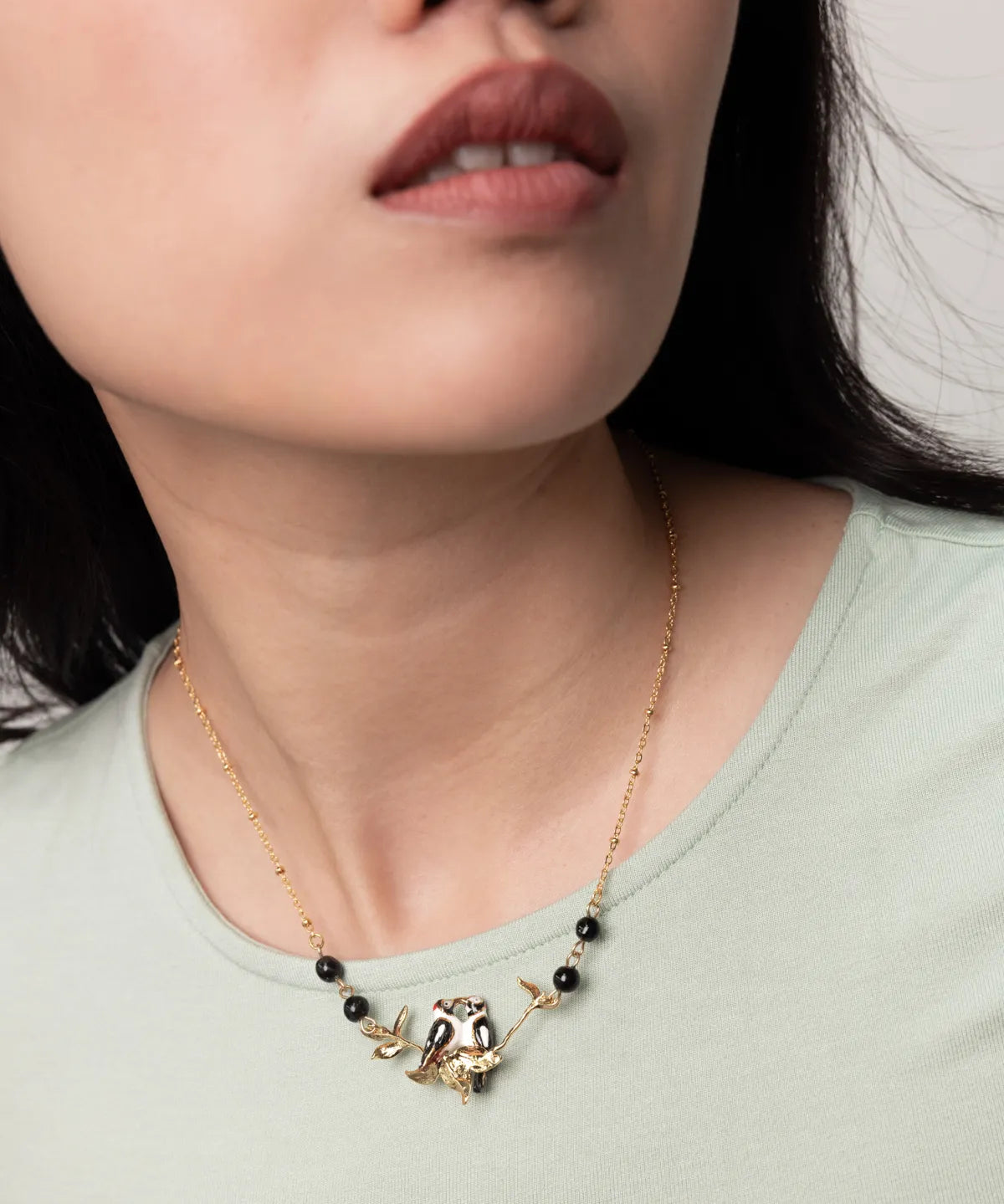 Bird necklace with spotted woodpeckers on a branch