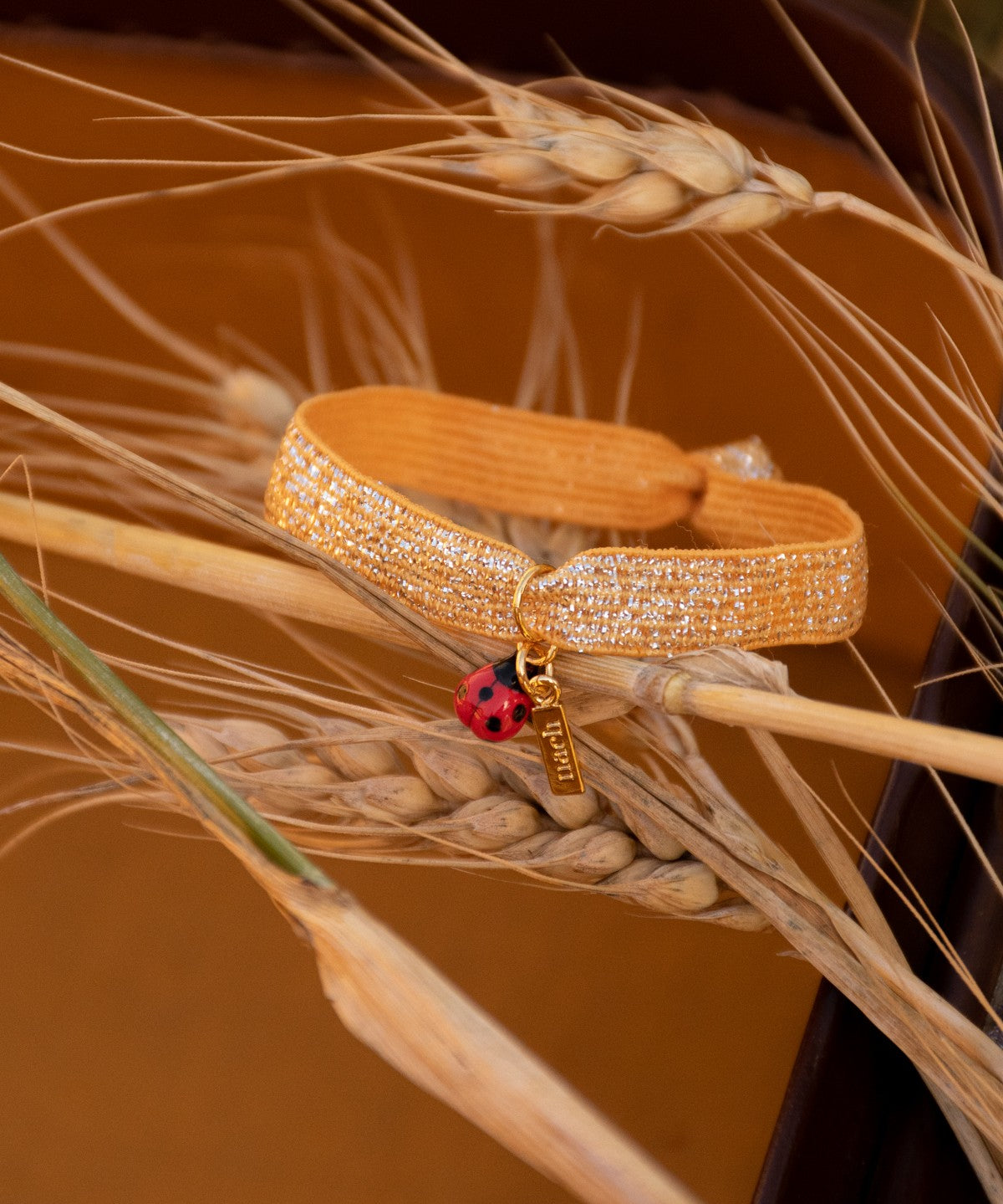 Bracelet élastique orange brillant coccinelle