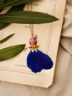 golden necklace blue parrot pink feather