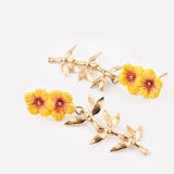Double hibiscus and leaf drop earrings