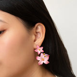 Boucles d’oreilles pendantes double lys roses