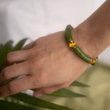 Bracelet perles vertes oiseau de paradis